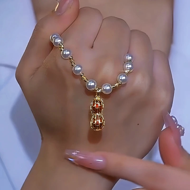 Close-up of the pendant and clasp on the Peanut Pearl Necklace