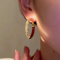 Close-up detail of the sparkling zircons and plating on the Red Hoop Earrings