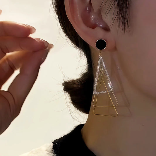 Model showcasing the dangle and style of the 14K Gold-Plated Diamond-Studded Three-Dimensional Multi-Layer Triangle Earrings