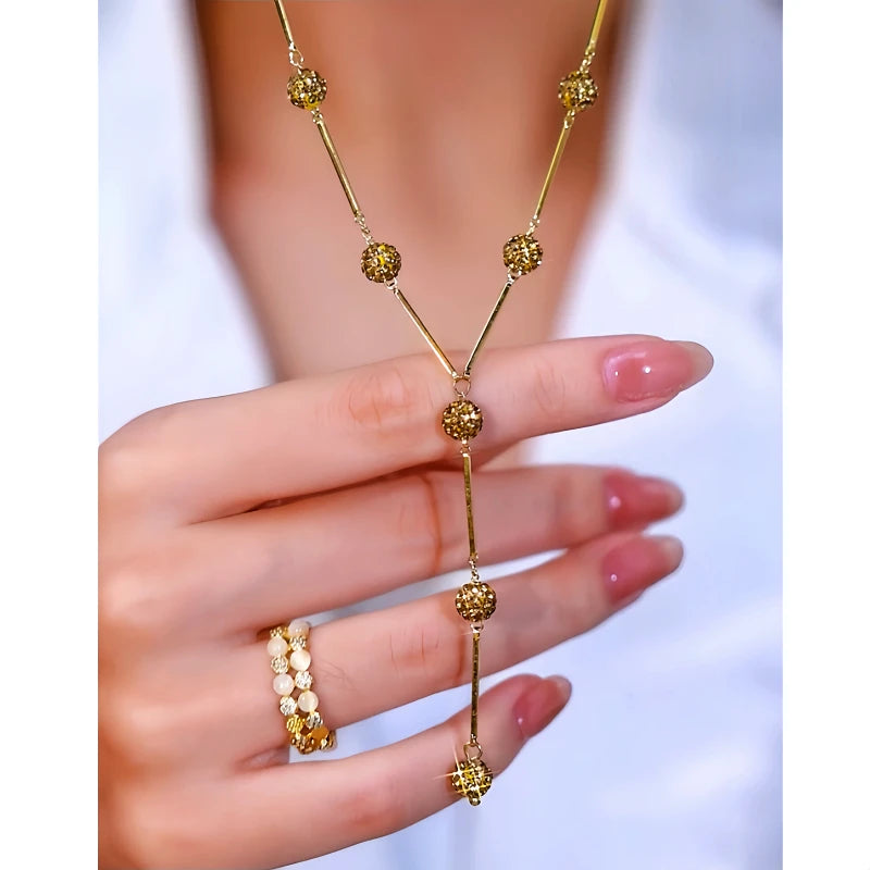 Detailed view of the 14K Gold-Plated Diamond-Studded Y-Shaped Coffee-Colored Diamond Ball Necklace chain and pendant