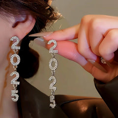 Model showcasing the dangle and style of the 14K Gold-Plated Diamond 2025 Digital Earrings