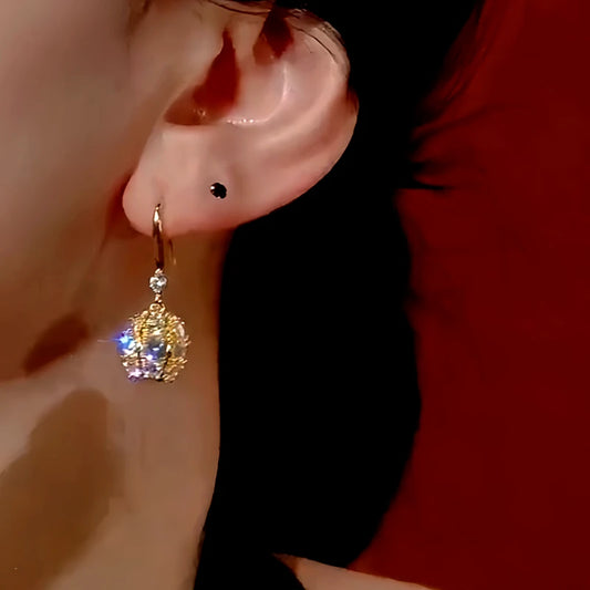 Model showcasing the dangle and style of the 14K Gold-Plated Diamond Ball Ear Hook Earrings