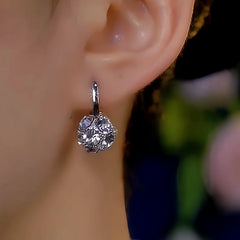 Model showcasing the dangle and style of the 14K Gold-Plated Diamond Ball Earrings
