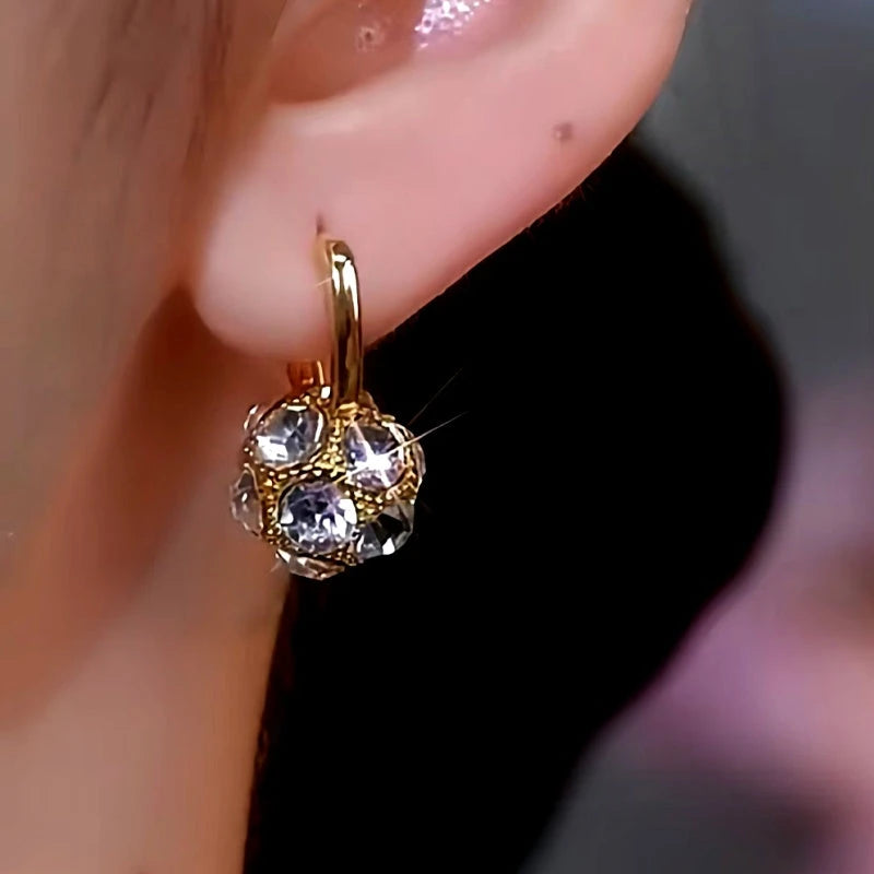 Close-up detail of the sparkling zircons and plating on the Golden Diamond Ball Earrings