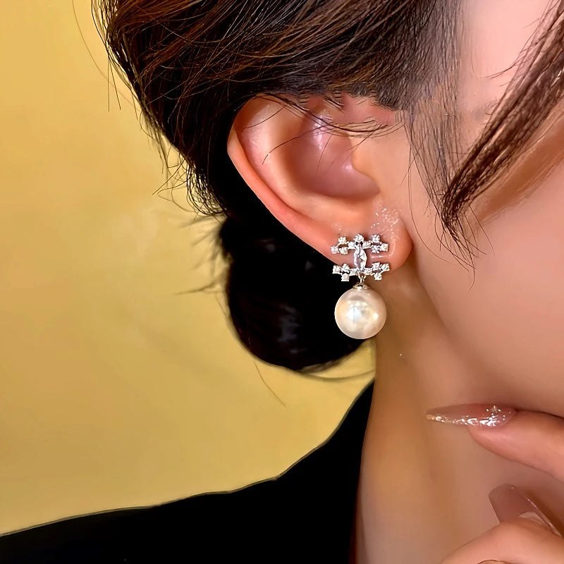 Model showcasing the dangle and style of the 14K Gold-Plated Diamond Bead Earrings