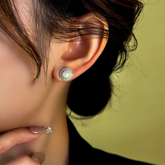 Model showcasing the dangle and style of the 14K Gold-Plated Diamond Bead Stud Earrings