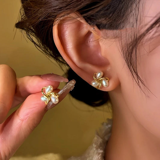 Model showcasing the dangle and style of the 14K Gold-Plated Diamond Bead Stud Earrings