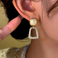 Model showcasing the dangle and style of the 14K Gold-Plated Diamond Bead Tassel Earrings