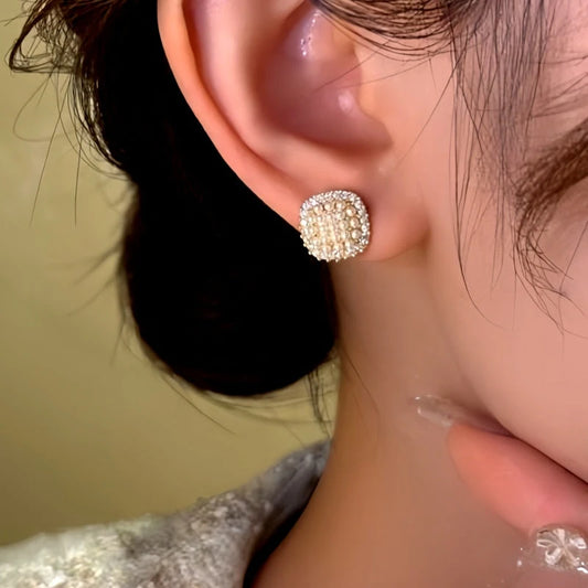 Model showcasing the dangle and style of the 14K Gold-Plated Diamond Beads Stud Earrings