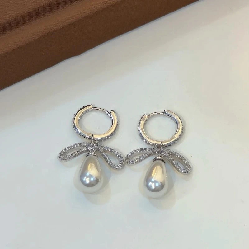 Angled view of the 14K Gold-Plated Diamond Bow Bead Earrings