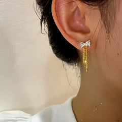 Close-up detail of the sparkling zircons and plating on the Golden Bow Earrings