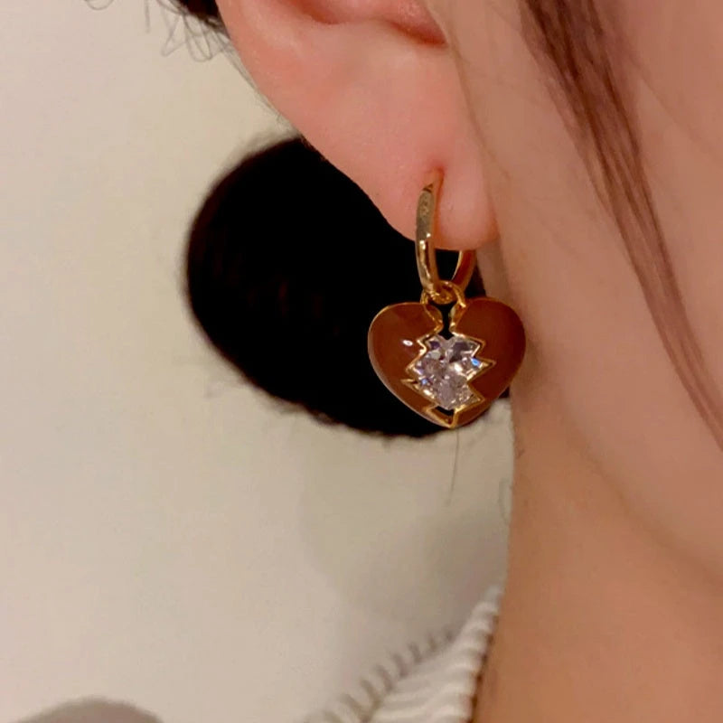 Model showcasing the dangle and style of the 14K Gold-Plated Diamond Broken Heart Earrings