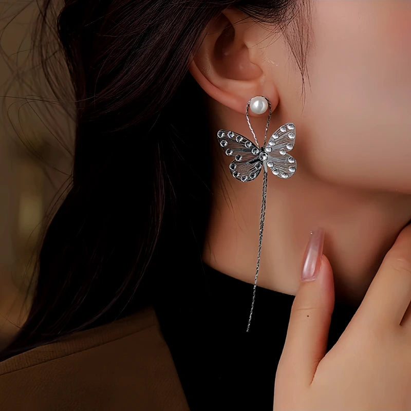 Model showcasing the dangle and style of the 14K Gold-Plated Diamond Butterfly Long Tassel Earrings