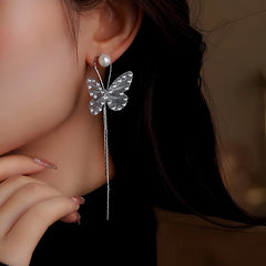 Angled view of the 14K Gold-Plated Diamond Butterfly Long Tassel Earrings