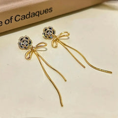 Angled view of the 14K Gold-Plated Diamond Camellia Flower Tassel Earrings