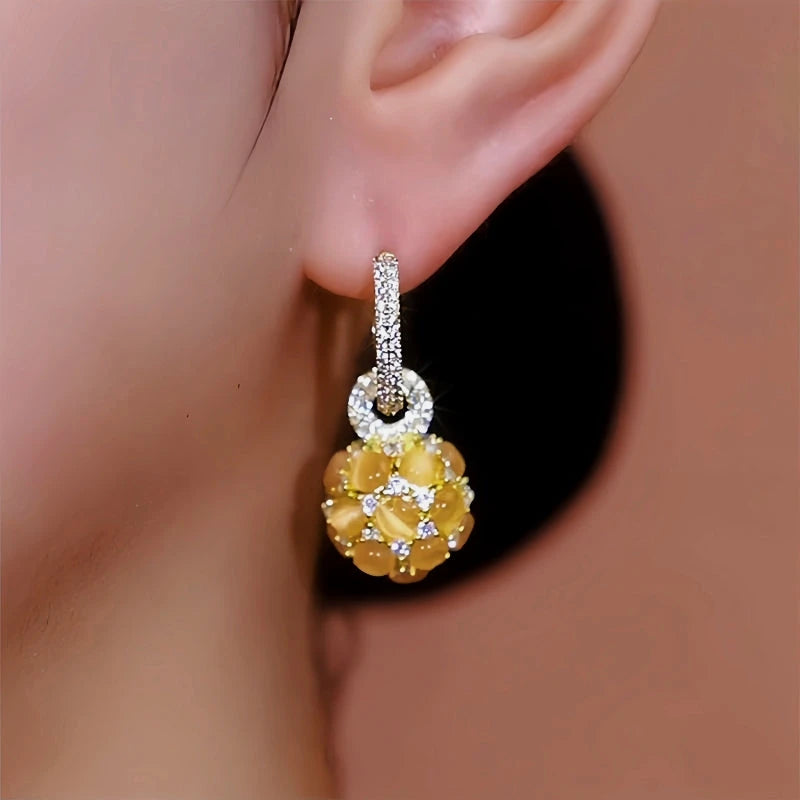 Close-up detail of the sparkling zircons and plating on the Cat's Eye Ball Earrings