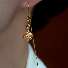 Close-up detail of the sparkling zircons and plating on the Cat's Eye Threader Earrings