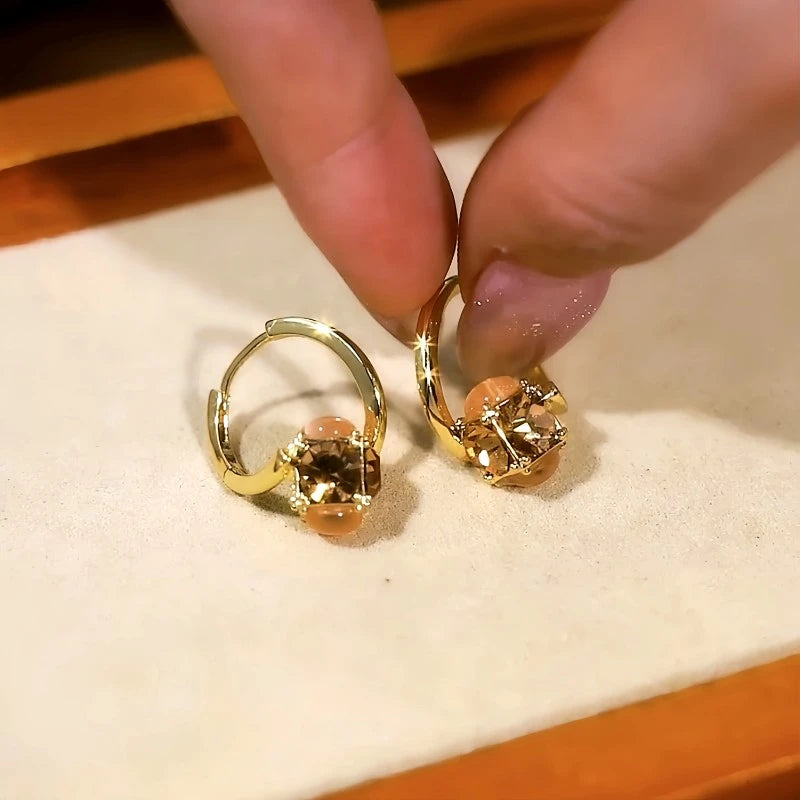 Model showcasing the dangle and style of the 14K Gold-Plated Diamond Cat's Eye Stone Earrings