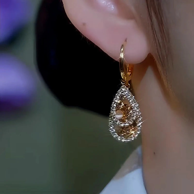 Close-up detail of the sparkling zircons and plating on the Cat's Eye Water Drop Earrings