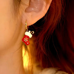 Model showcasing the dangle and style of the 14K Gold-Plated Diamond Christmas Stock Earrings