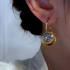 Close-up detail of the sparkling zircons and plating on the Diamond Disc Earrings