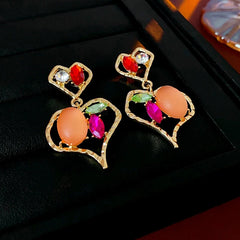 Model showcasing the dangle and style of the 14K Gold-Plated Diamond Double-Heart Earrings