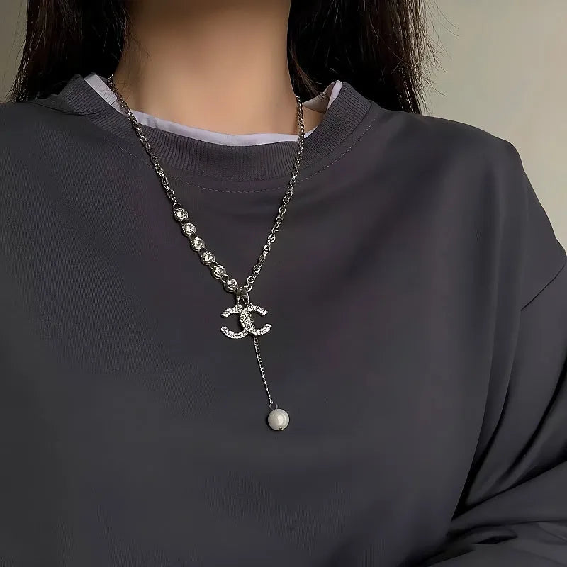 Close-up of the pendant and clasp on the Double C Necklace