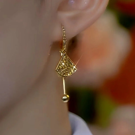 Model showcasing the dangle and style of the 14K Gold-Plated Diamond Fan-Shaped Earrings