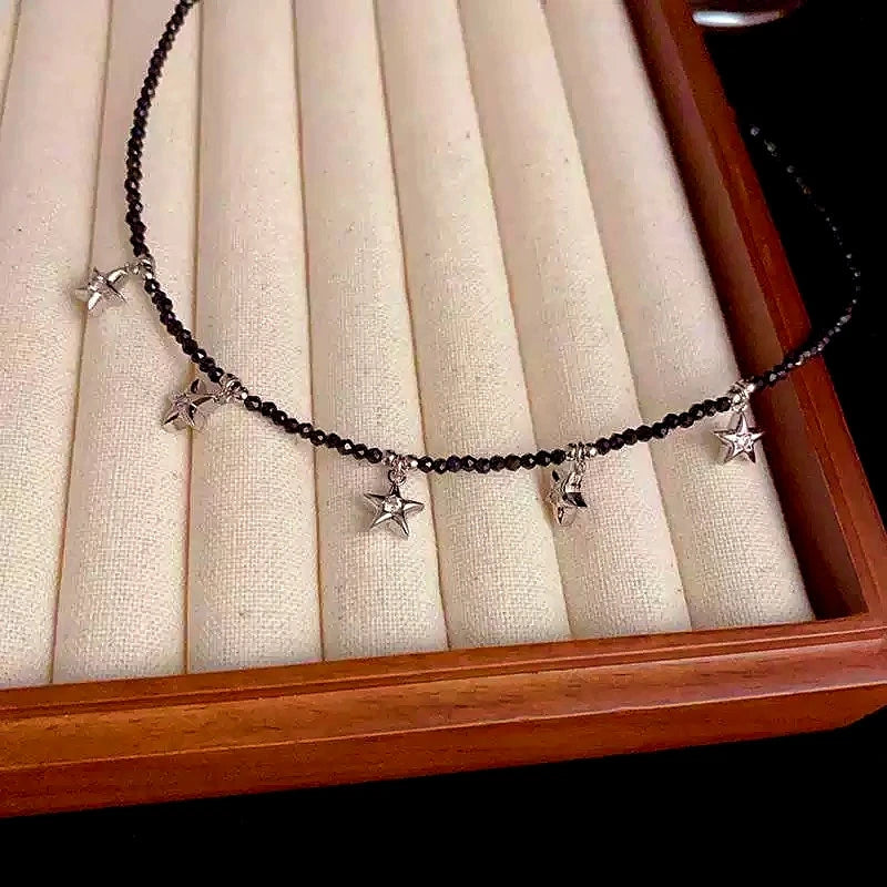 Close-up of the pendant and clasp on the Five Star Necklace