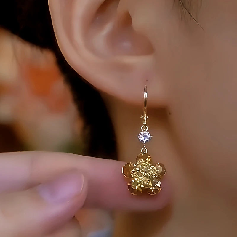 Close-up detail of the sparkling zircons and plating on the Golden Flower Earrings