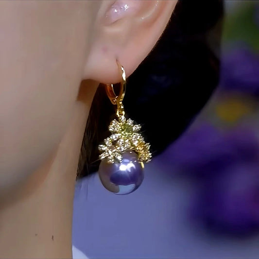 Model showcasing the dangle and style of the 14K Gold-Plated Diamond Flower Purple Pearl Earrings