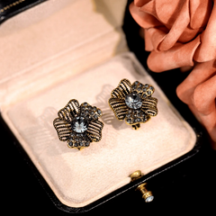Angled view of the 14K Gold-Plated Diamond Flower Stud Earrings