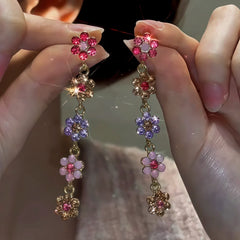 Angled view of the 14K Gold-Plated Diamond Flower Tassel Earrings