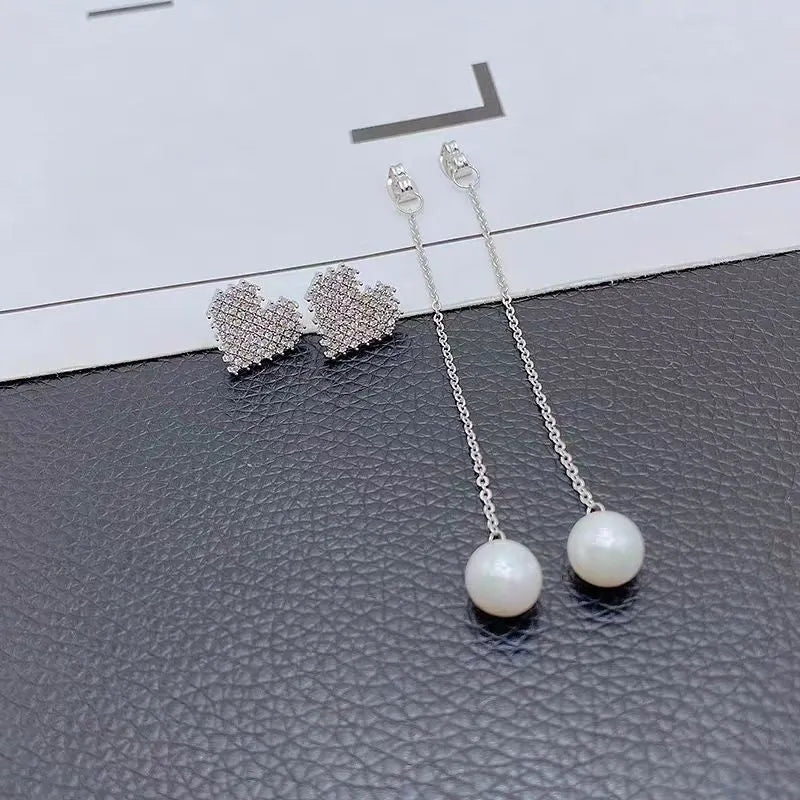 Model showcasing the dangle and style of the 14K Gold-Plated Diamond Heart Pearl Tassel Earrings