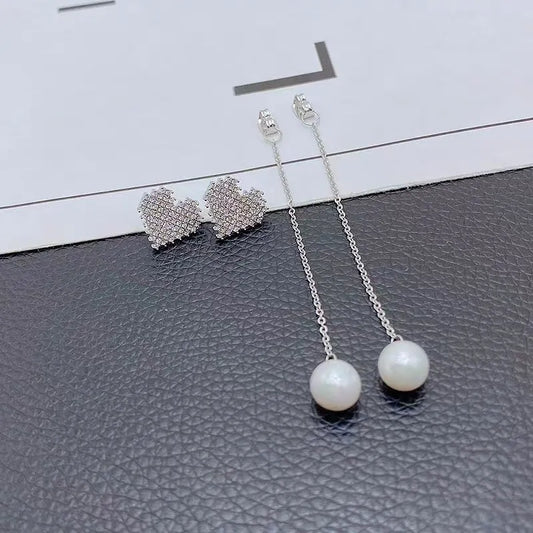 Model showcasing the dangle and style of the 14K Gold-Plated Diamond Heart Pearl Tassel Earrings