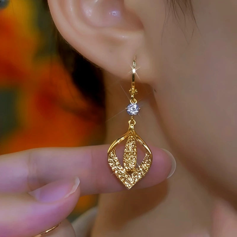 Close-up detail of the sparkling zircons and plating on the Gold Leaf Earrings