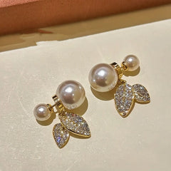 Angled view of the 14K Gold-Plated Diamond Leaf Pearl Earrings