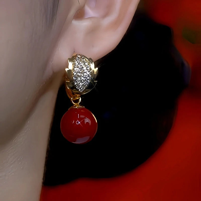 Close-up detail of the sparkling zircons and plating on the Red Pearl Earrings