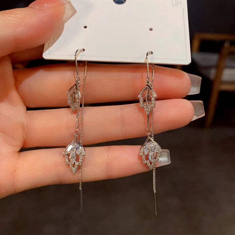 Angled view of the 14K Gold-Plated Diamond Leaf Threader Tassel Earrings