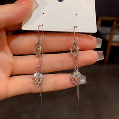 Angled view of the 14K Gold-Plated Diamond Leaf Threader Tassel Earrings