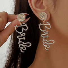 Model showcasing the dangle and style of the 14K Gold-Plated Diamond Letter Tassel Earrings