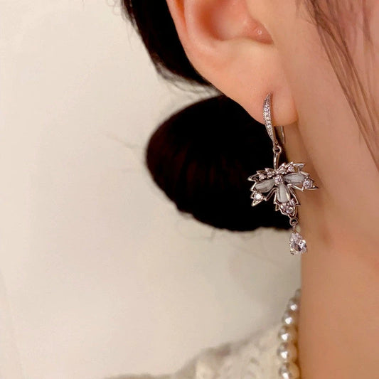 Model showcasing the dangle and style of the 14K Gold-Plated Diamond Maple Leaf Water Drop Ear Hooks
