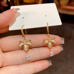 Close-up detail of the sparkling zircons and plating on the Maple Leaf Earrings