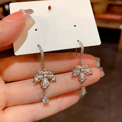 Angled view of the 14K Gold-Plated Diamond Maple Leaf Water Drop Ear Hooks