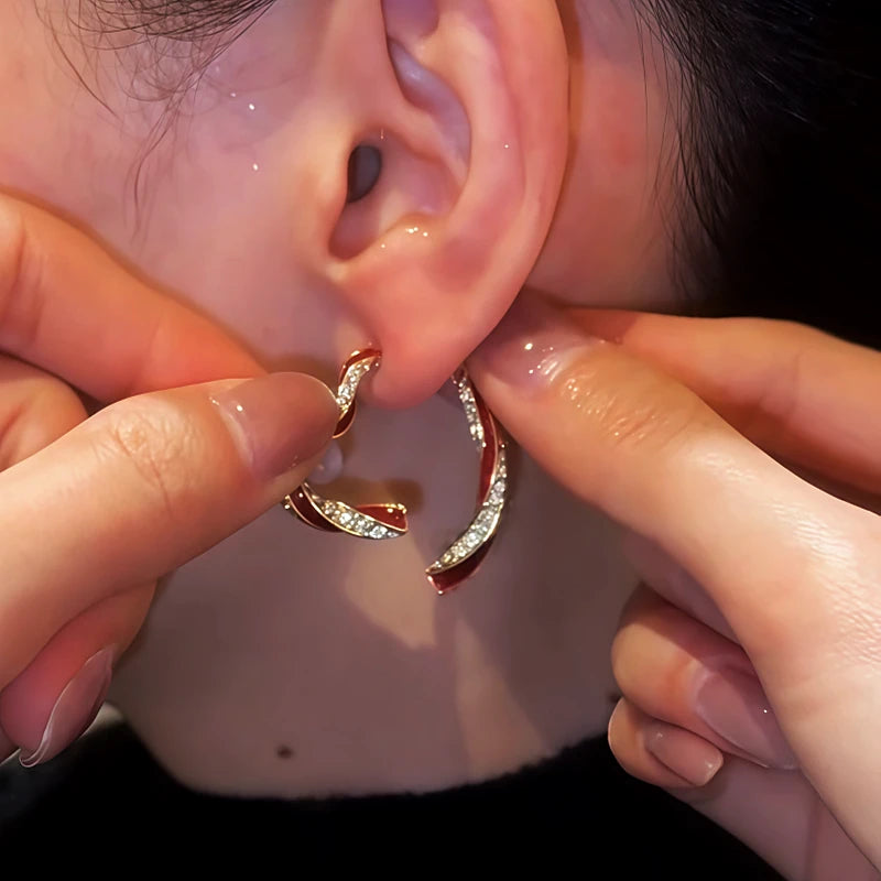 Angled view of the 14K Gold-Plated Diamond Oil Drop Heart-Design Earrings