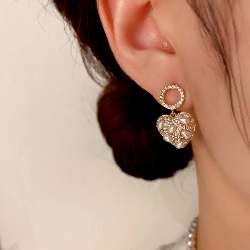 Close-up detail of the sparkling zircons and plating on the Pearl Heart Earrings