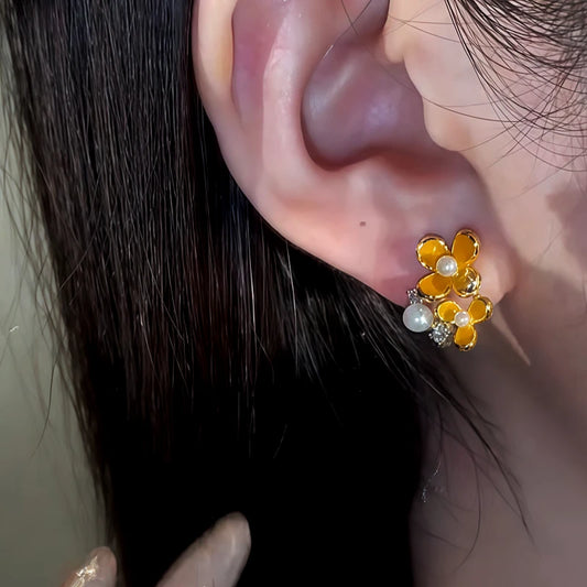 Model showcasing the dangle and style of the 14K Gold-Plated Diamond Pearl Osmanthus Stud Earrings