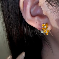 Model showcasing the dangle and style of the 14K Gold-Plated Diamond Pearl Osmanthus Stud Earrings