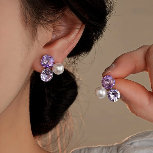 Model showcasing the dangle and style of the 14K Gold-Plated Diamond Pearl Stud Earrings