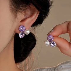 Model showcasing the dangle and style of the 14K Gold-Plated Diamond Pearl Stud Earrings